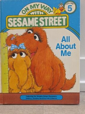 Sesame Street Book Featuring Orange Furry Characters with Blue Accents